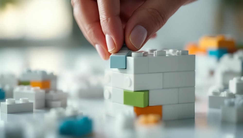 Person adding the very last brick in a build