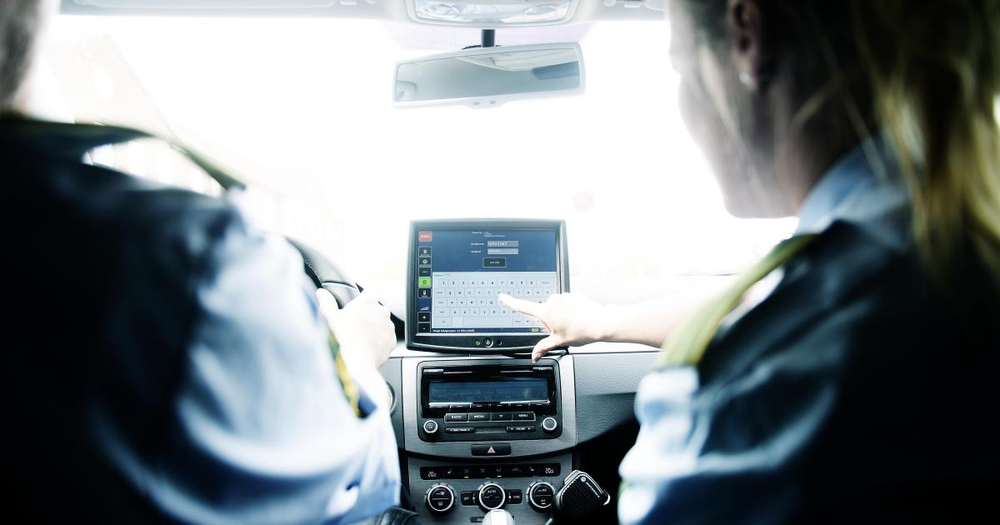 Two danish police officers in a patrol car