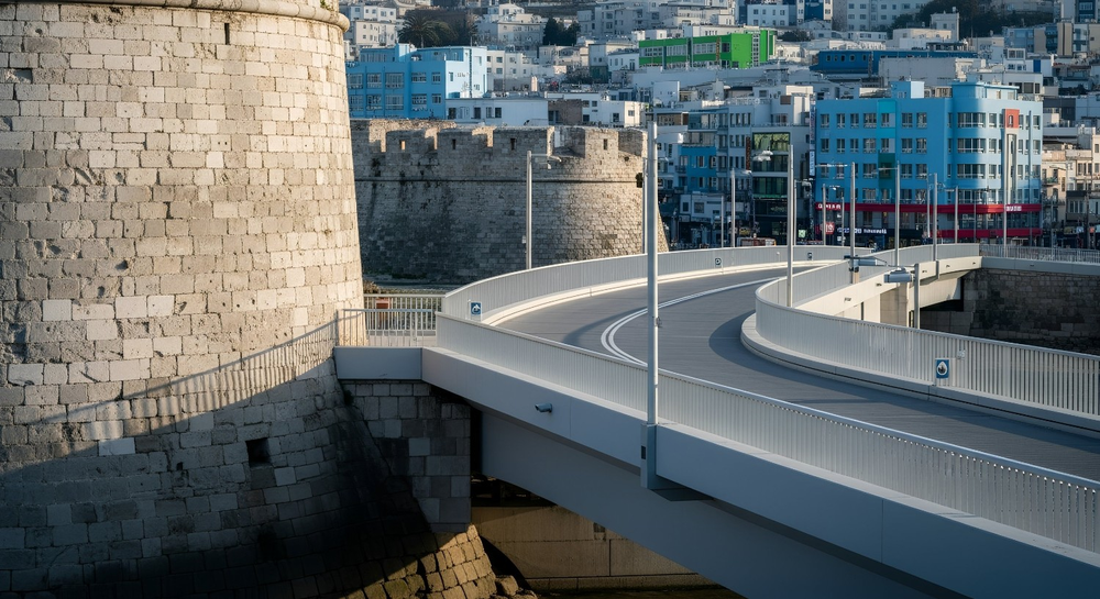 A sturdy bridge connecting an old fortress to a thriving modern city, representing efficiency gains without altering core systems